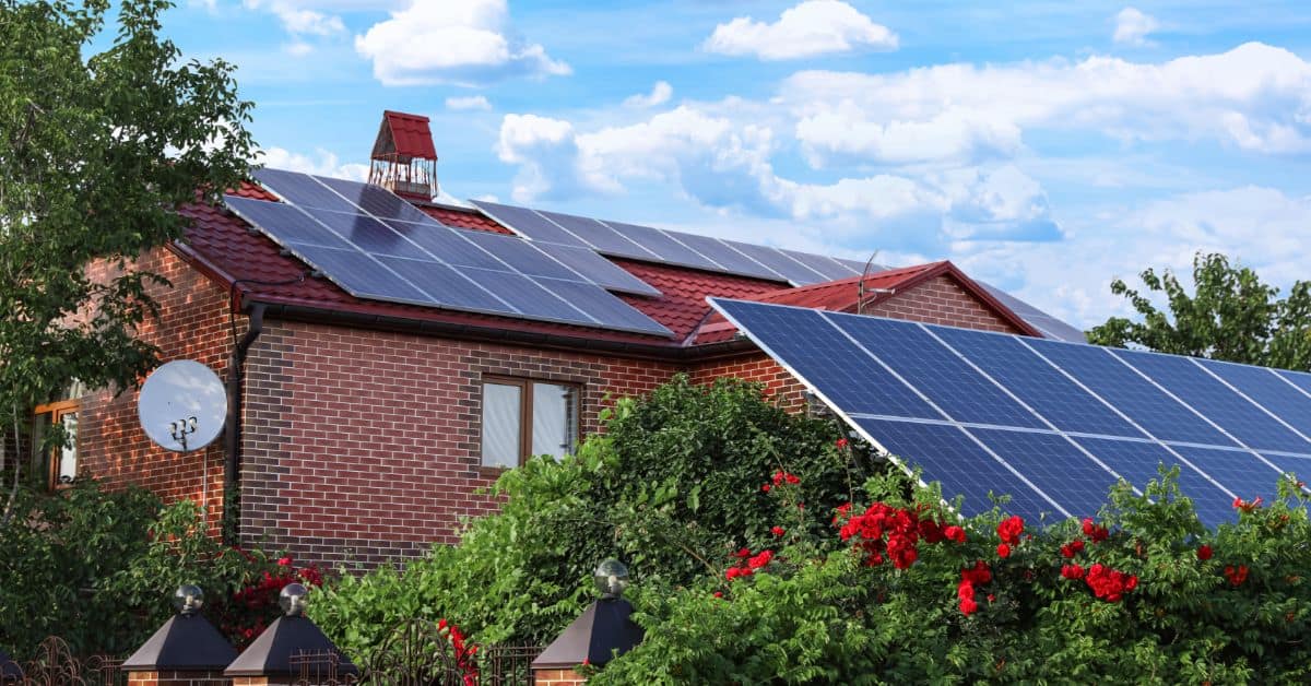 Green Building - House with Solar Panels on Roof