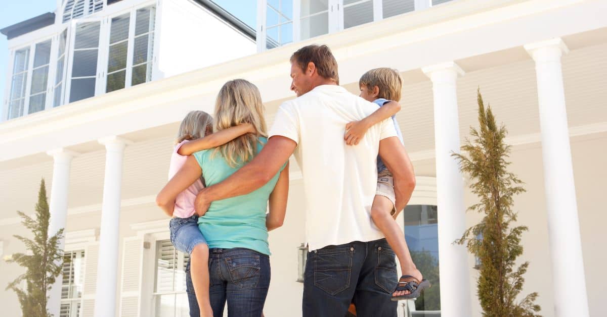 Home Construction - Family standing infront of house