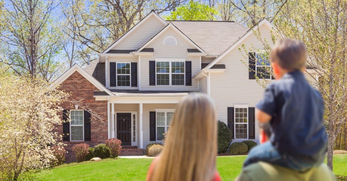Family staring at their home