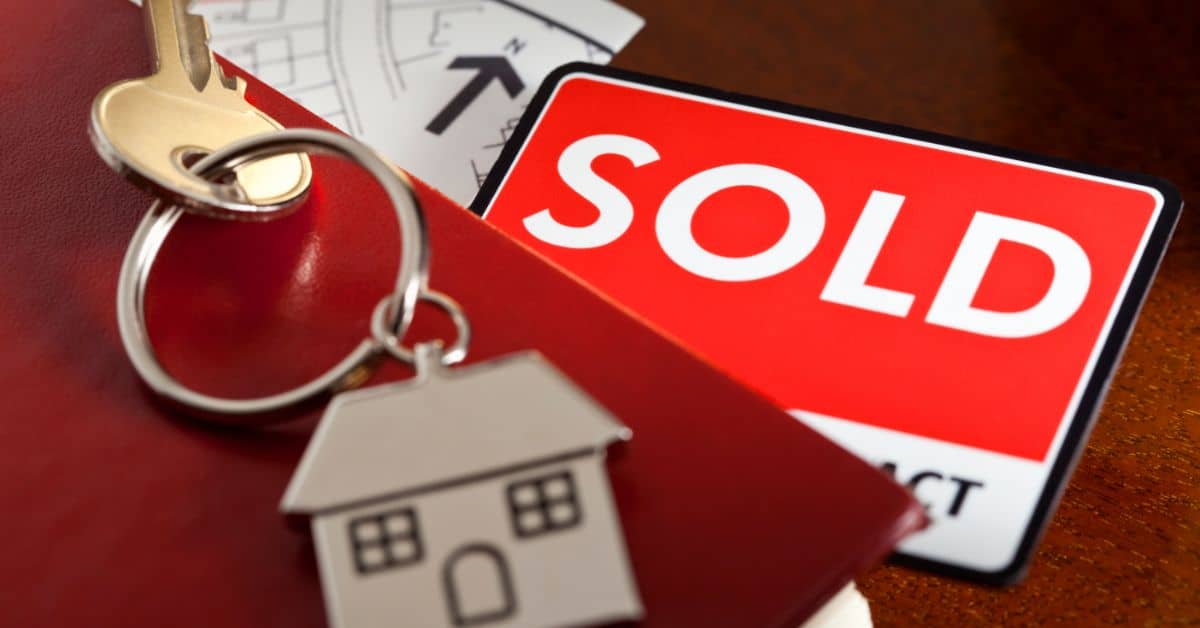 Sold sign with a house shaped keyring
