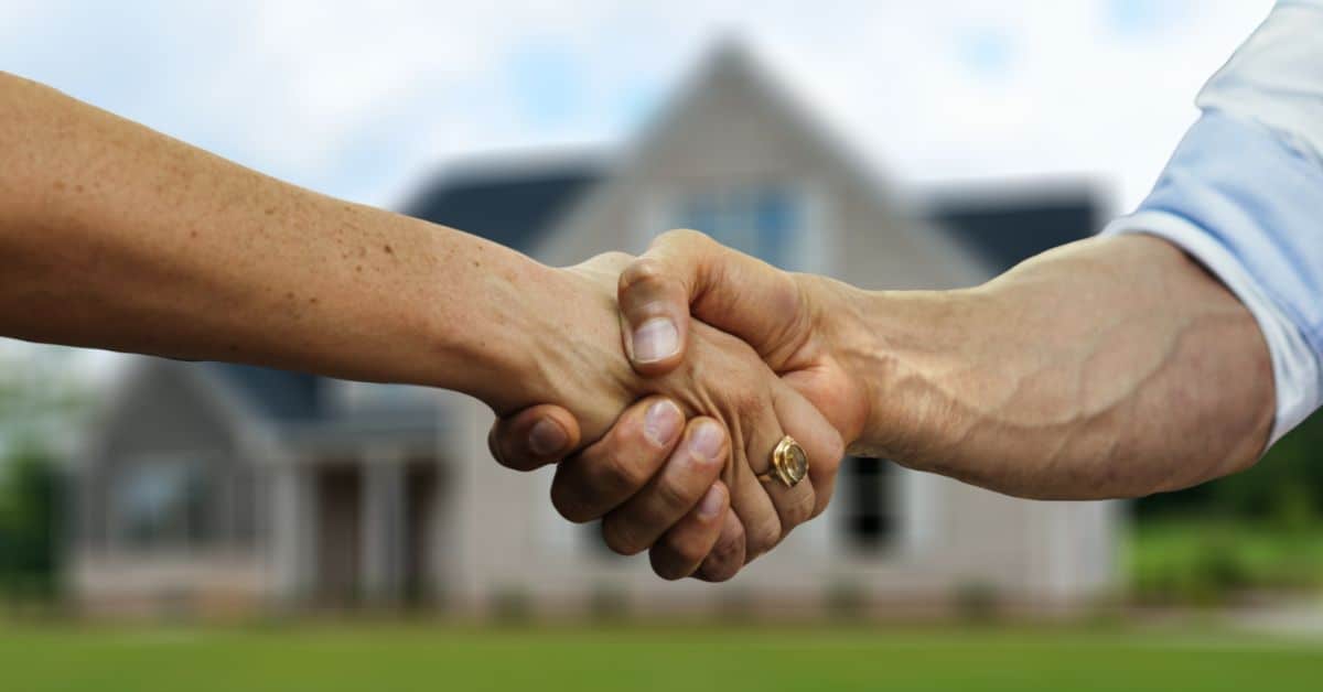 People Shaking Hands over House Registration
