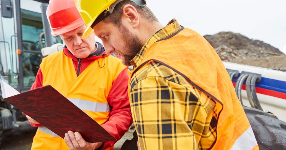 house construction - contractors checking building permit