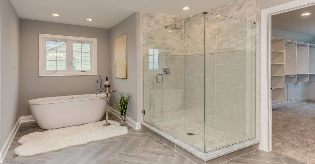 Elegant bathroom with a freestanding tub and glass shower enclosure for a seamless renovation.