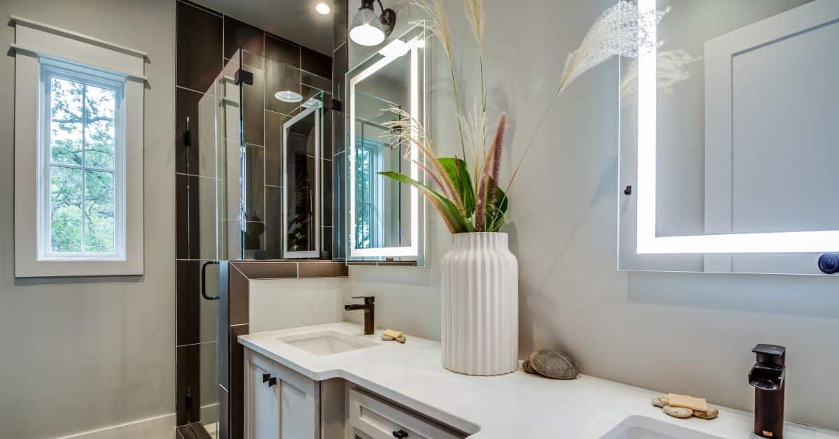 Modern bathroom with sleek fixtures, large mirror, and natural light in Cape Town home.