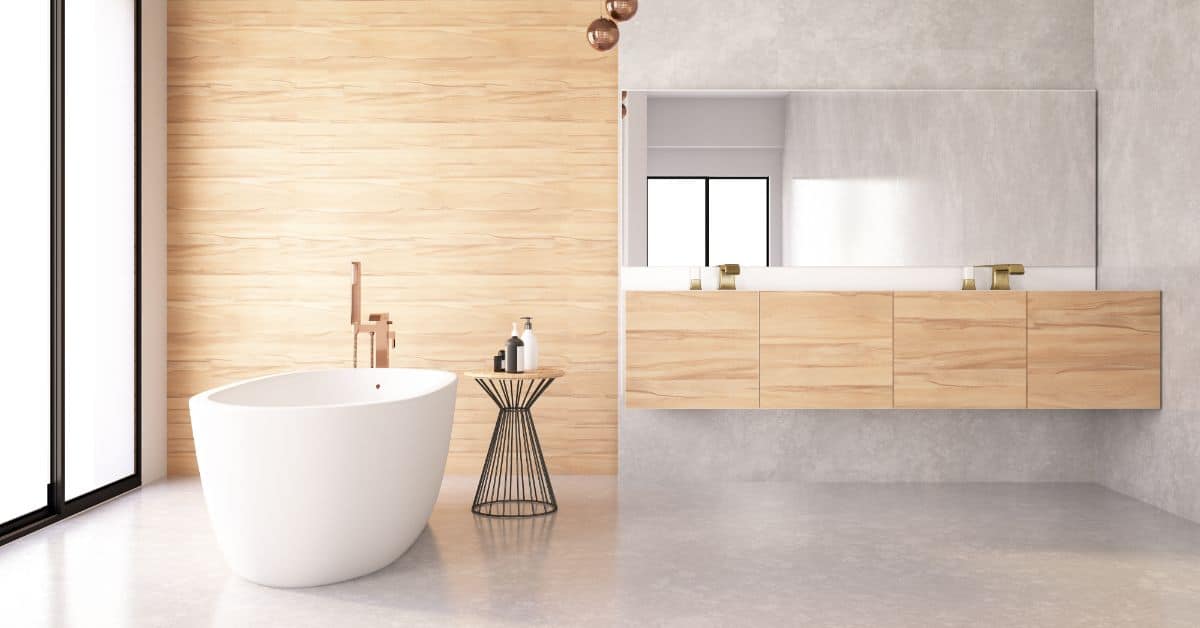 Freestanding bathtub with wooden vanity and minimalist decor in a contemporary bathroom setting.