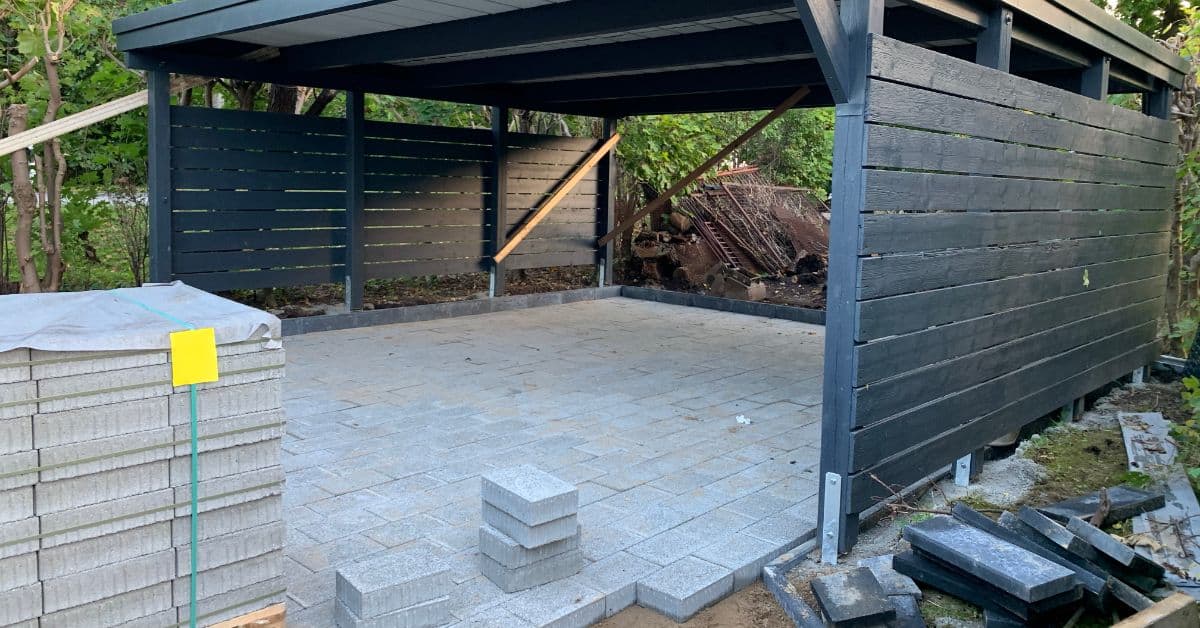 Black wooden carport providing durable shelter for vehicles against Cape Town’s weather conditions.