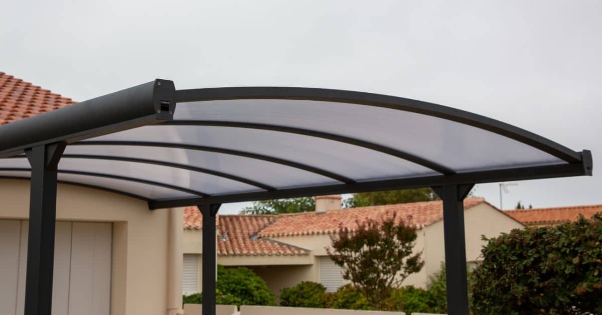 Aluminum carport shielding vehicle from rain and sun in Cape Town.