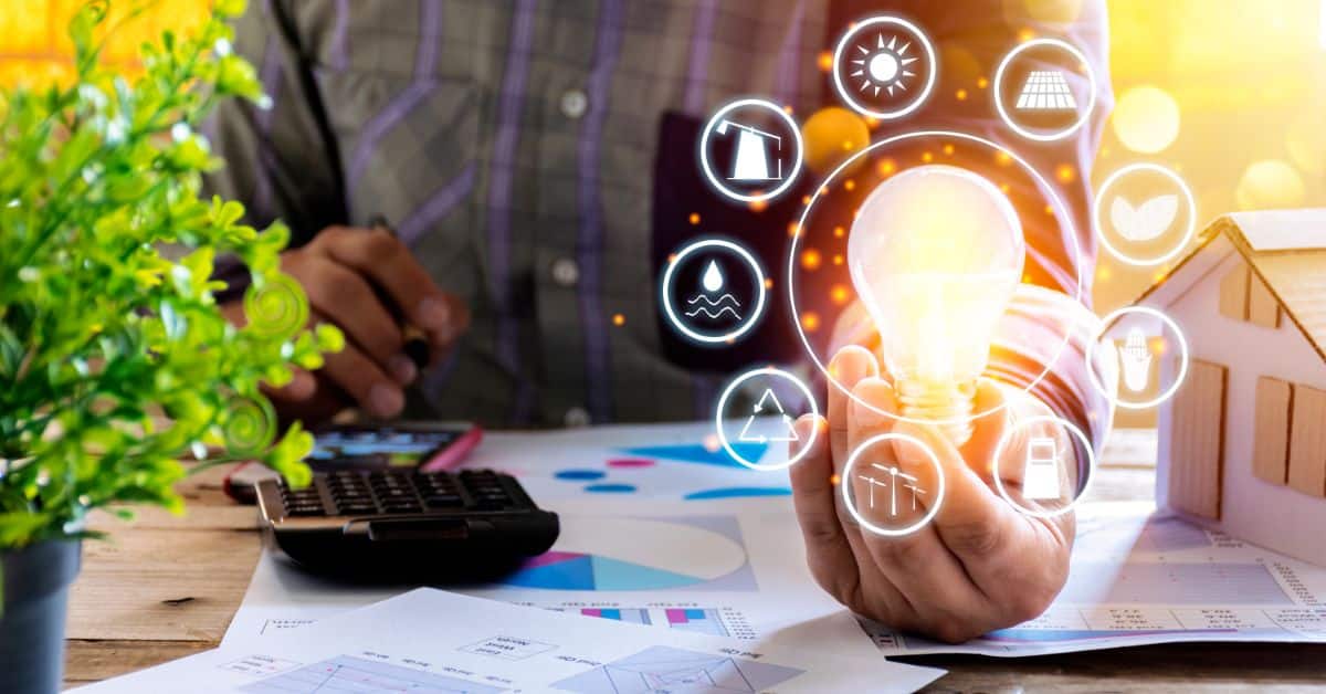 Person holding a glowing light bulb with solar icons, promoting solar energy benefits.