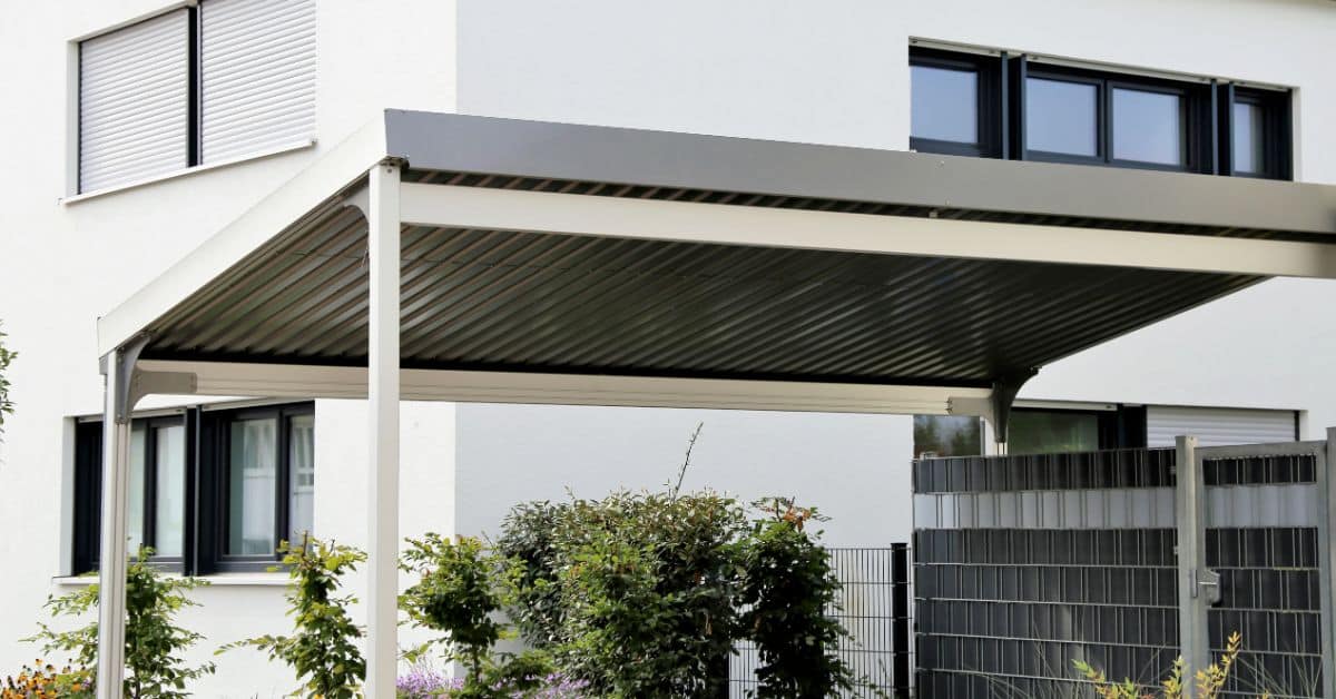 Modern white carport protecting vehicle from weather in Cape Town.
