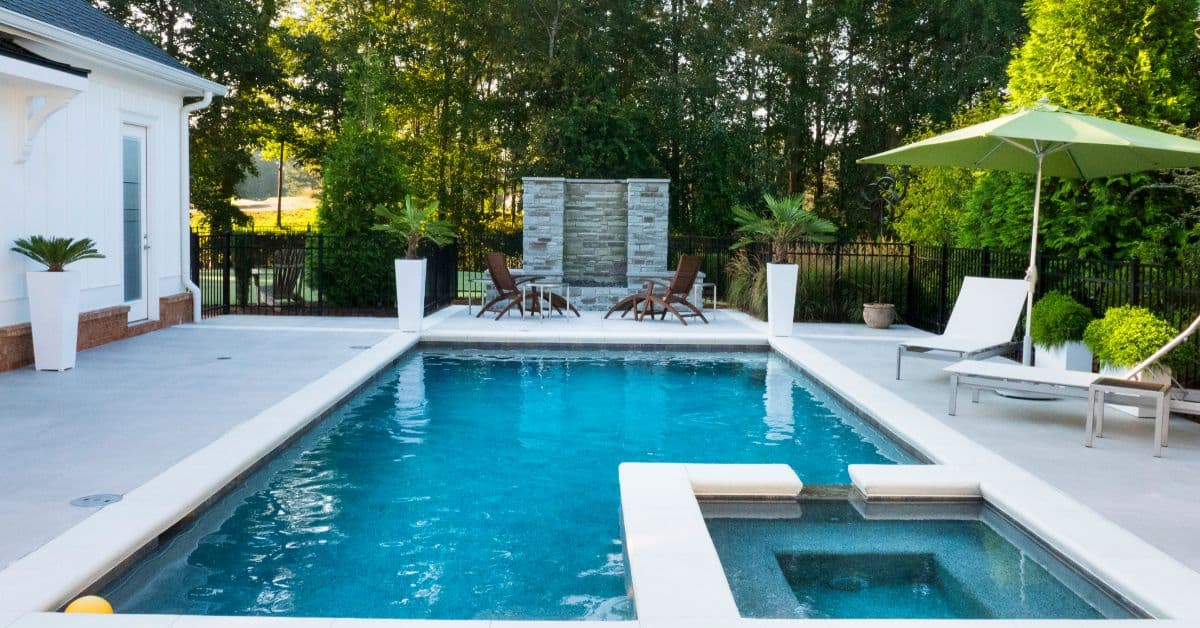Beautiful backyard pool with spa, lounge chairs, and lush greenery in Cape Town.
