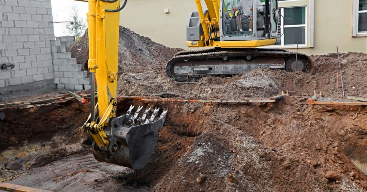 Excavator digging for swimming pool construction in Cape Town.