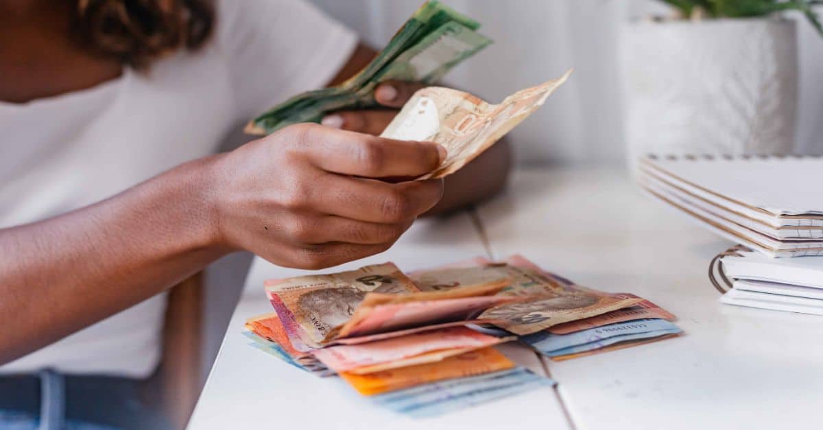 Lady counting South African rands