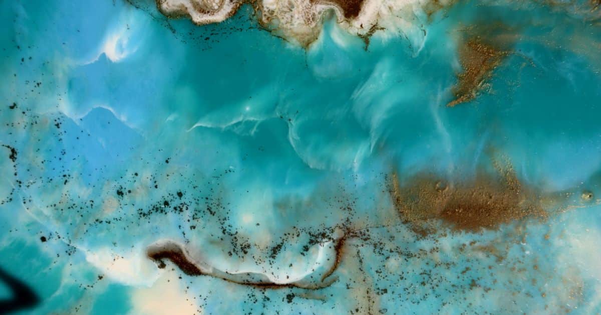 Vibrant epoxy floor with swirling blue and brown patterns in a modern space.