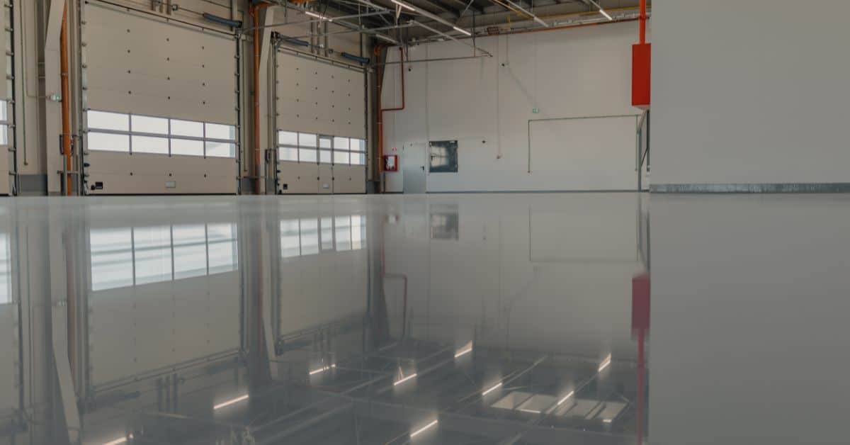 High-gloss epoxy flooring in a spacious industrial warehouse setting.