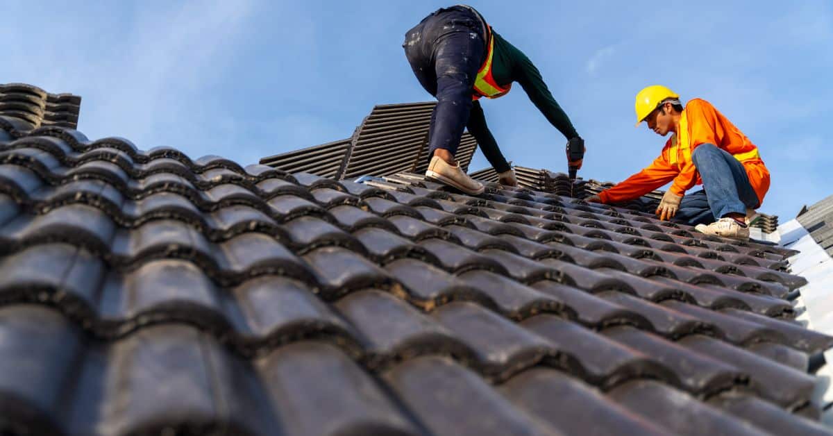Skilled workers installing durable roof tiles on a Cape Town home roof.