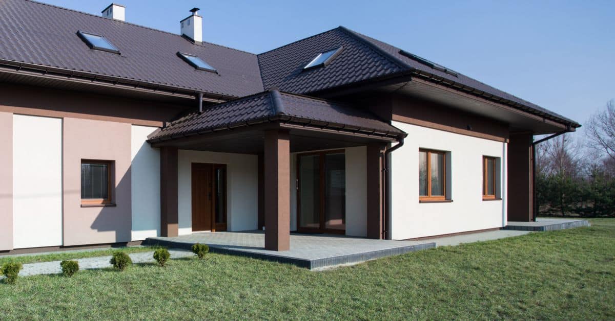 Contemporary single storey house with dark roof and large windows in South Africa.