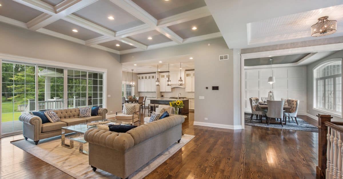 Spacious living room with large windows, stylish furniture, and open-plan design in a South African.