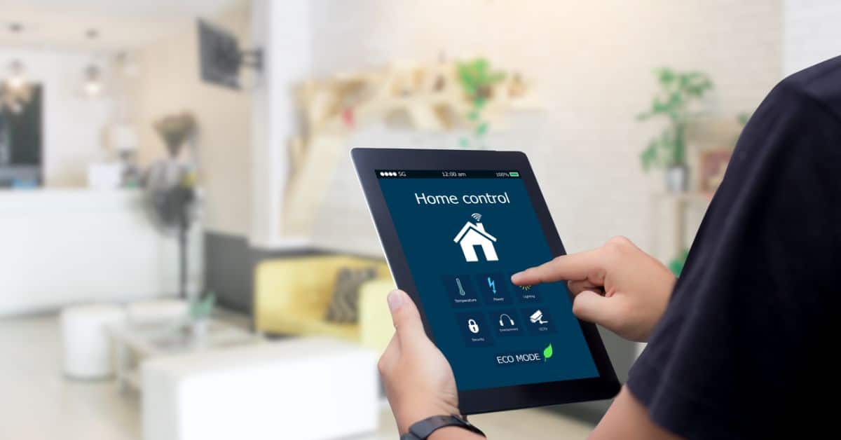 Person using smart home control tablet in a modern living room.