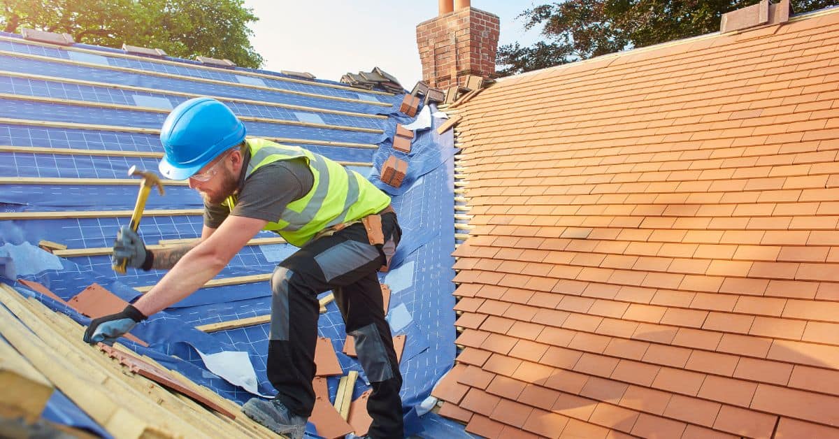 Roof tile installation on a Cape Town home with blue and terracotta tiles.