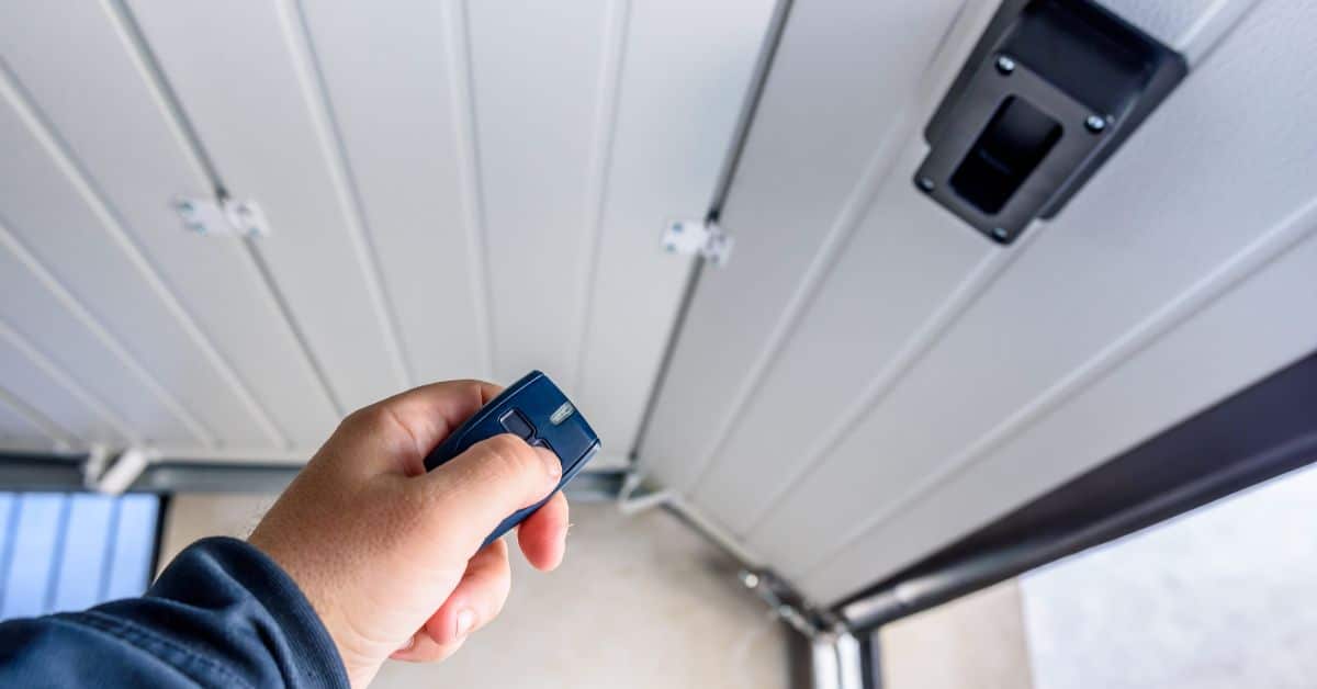 Man using remote to open roller door
