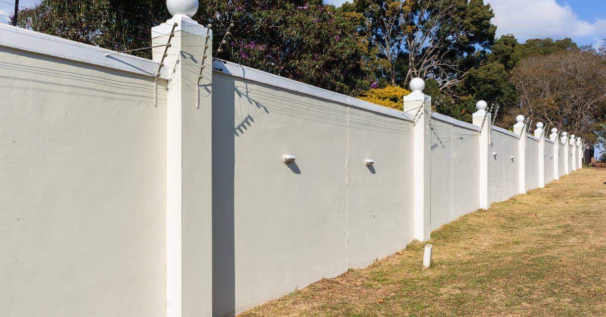 White boundary wall with decorative pillars for privacy and security in Cape Town.