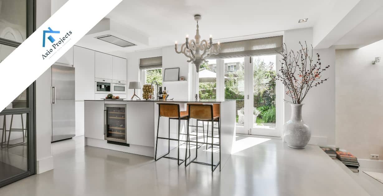 Contemporary white kitchen with island and large windows in South Africa.