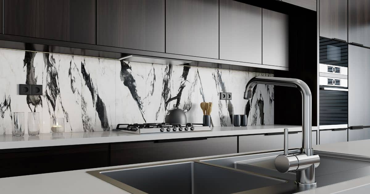 Elegant kitchen featuring a marble backsplash and sleek black cabinetry by Axio Projects.