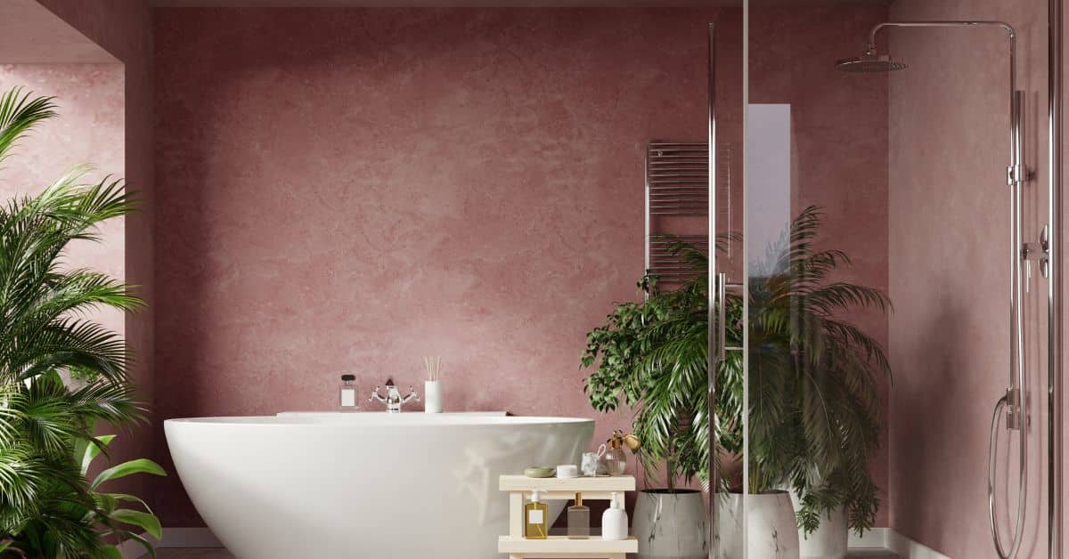 Elegant bathroom featuring a modern shower, freestanding bathtub, and lush green plants for a relaxi.