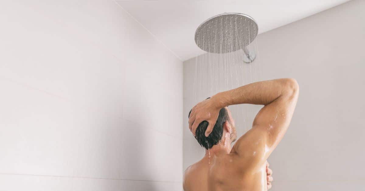Man showering with a rainfall showerhead