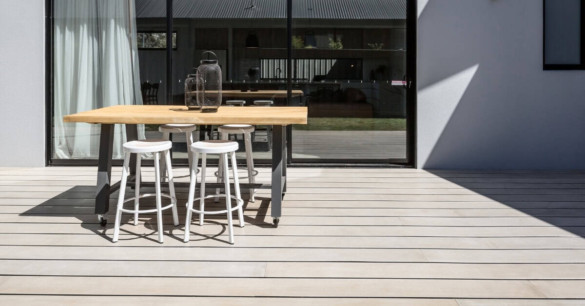Modern outdoor patio with composite decking and dining table for outdoor living.