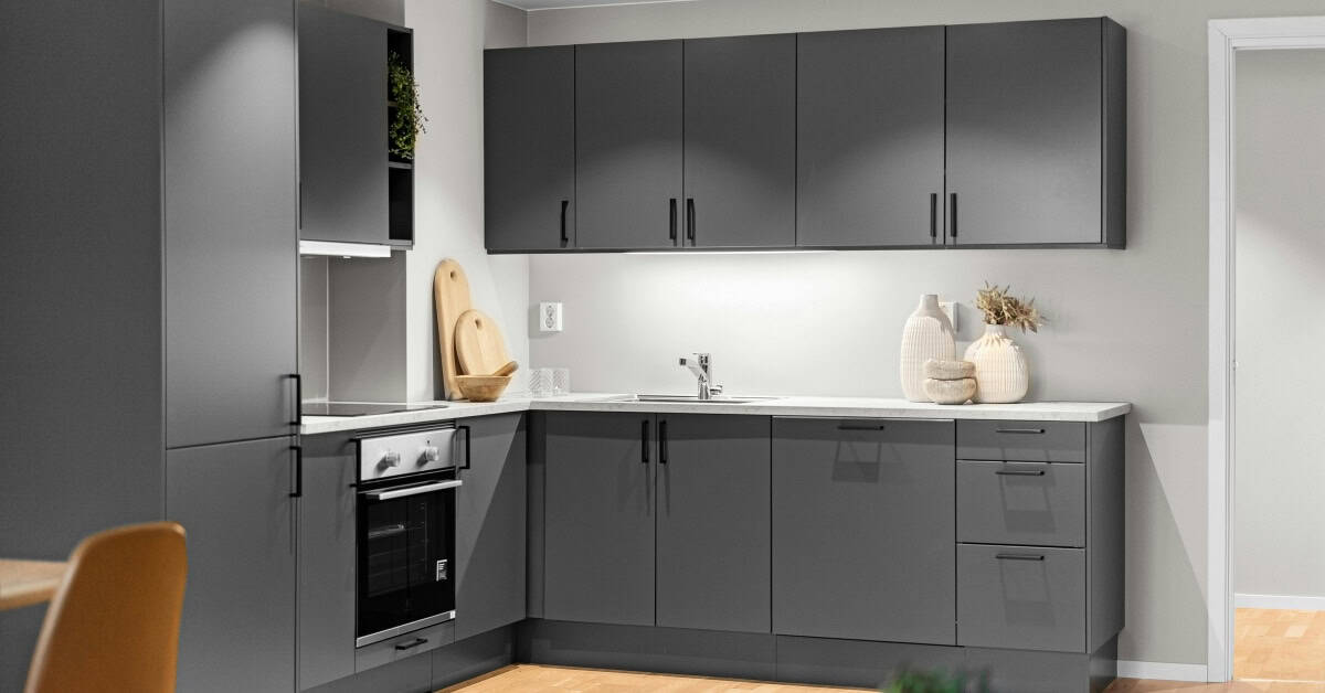 Modern kitchen cupboards with sleek gray finish and minimalist design.