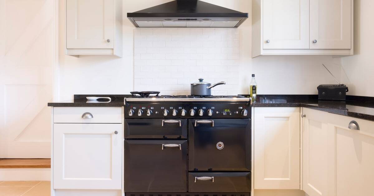 Modern kitchen with upgraded cupboards and a black stove for a stylish cooking space.