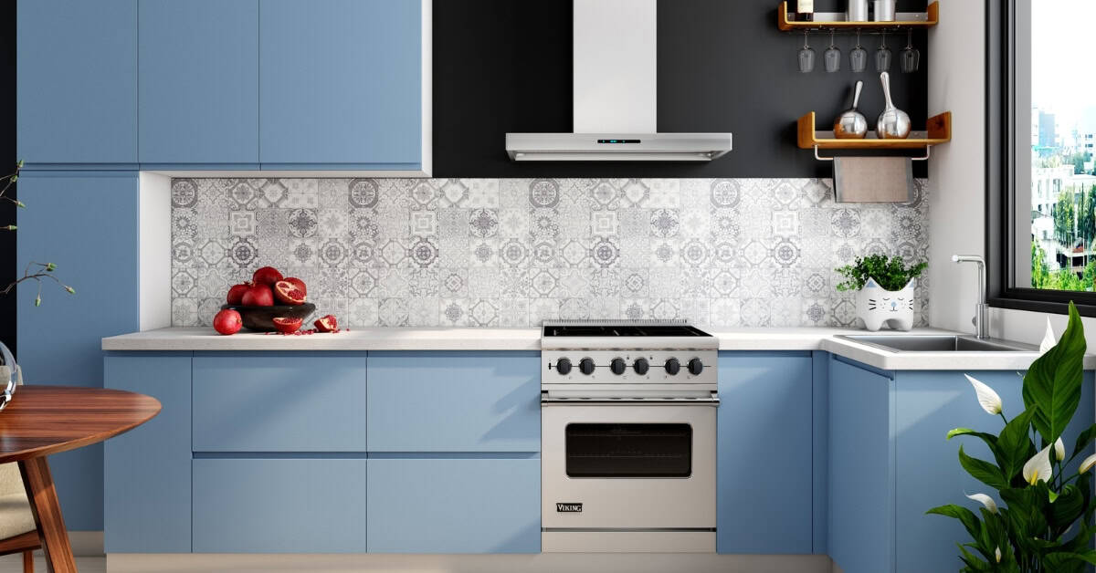 Bright blue kitchen cabinets with modern appliances and decorative tiles.