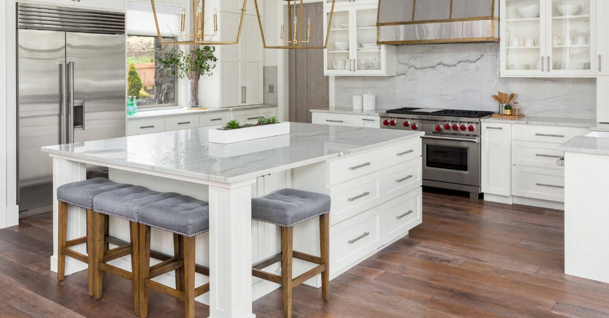 Bright modern kitchen with white cabinets and a large island for cooking and entertaining.