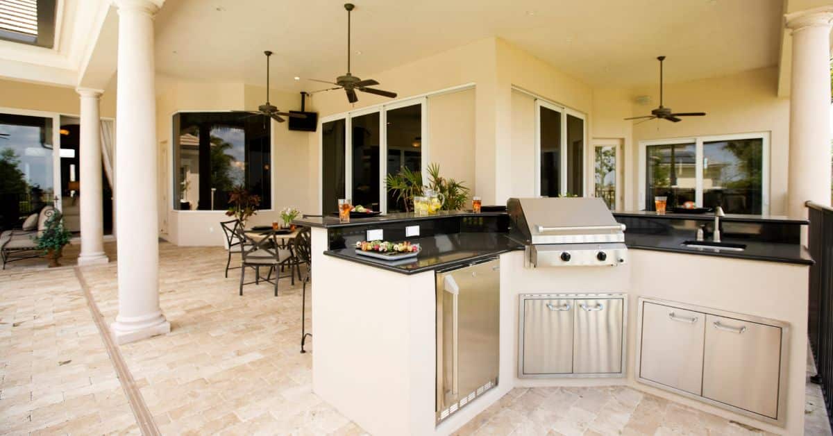 Outdoor kitchen with patio dining area and built-in grill for entertaining.