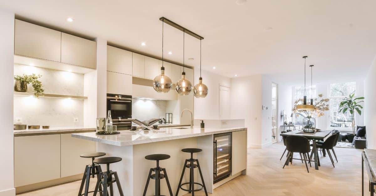 Contemporary open plan kitchen and lounge with sleek design and modern appliances.