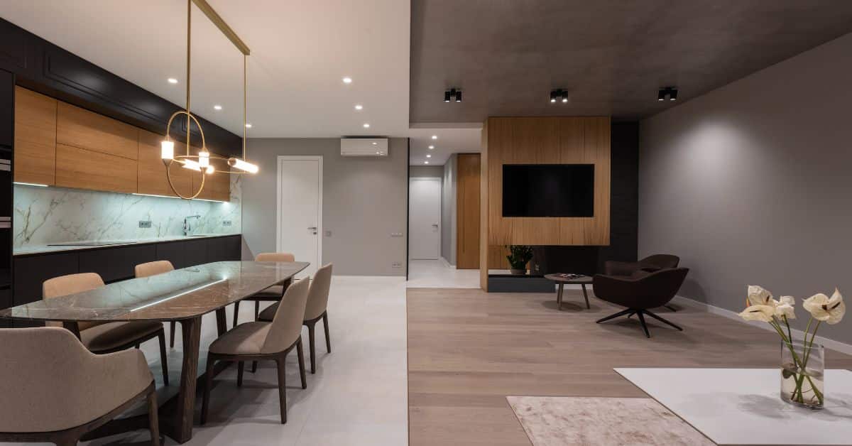 Open plan kitchen and lounge with contemporary design, wooden accents, and stylish furniture for a w.