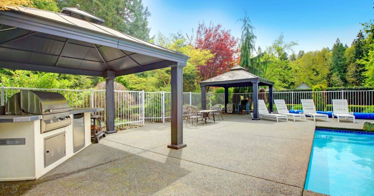 Beautiful outdoor entertainment area featuring a pool, lounge chairs, and shaded seating for relaxat.