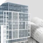 Contemporary glass commercial building with architectural plans in the background.