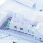 Modern house architectural model on blueprints, showcasing contemporary South African home design.