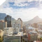 Cape Town city skyline with high-rise buildings and Table Mountain in the background.