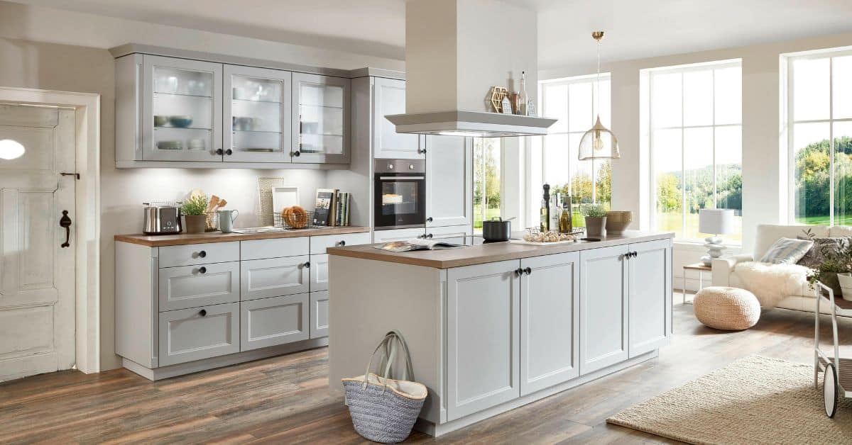 Contemporary kitchen with white cabinetry and large windows in South Africa.
