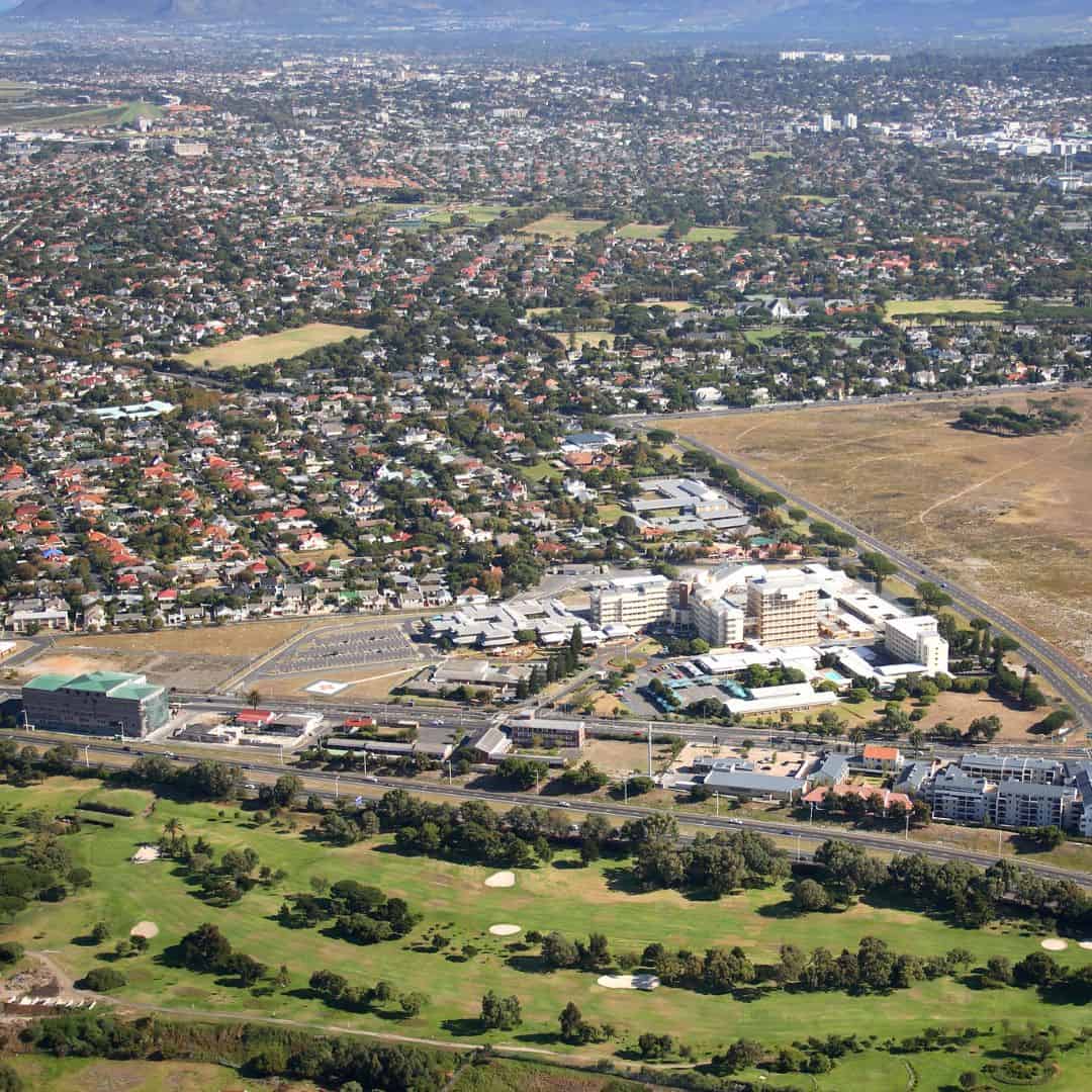 Aerial view of a residential area with a prominent building complex in Rondebosch.
