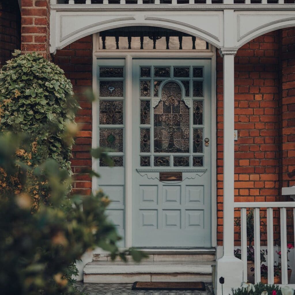 Elegant front door of a Rondebosch home with intricate stained glass and classic design.
