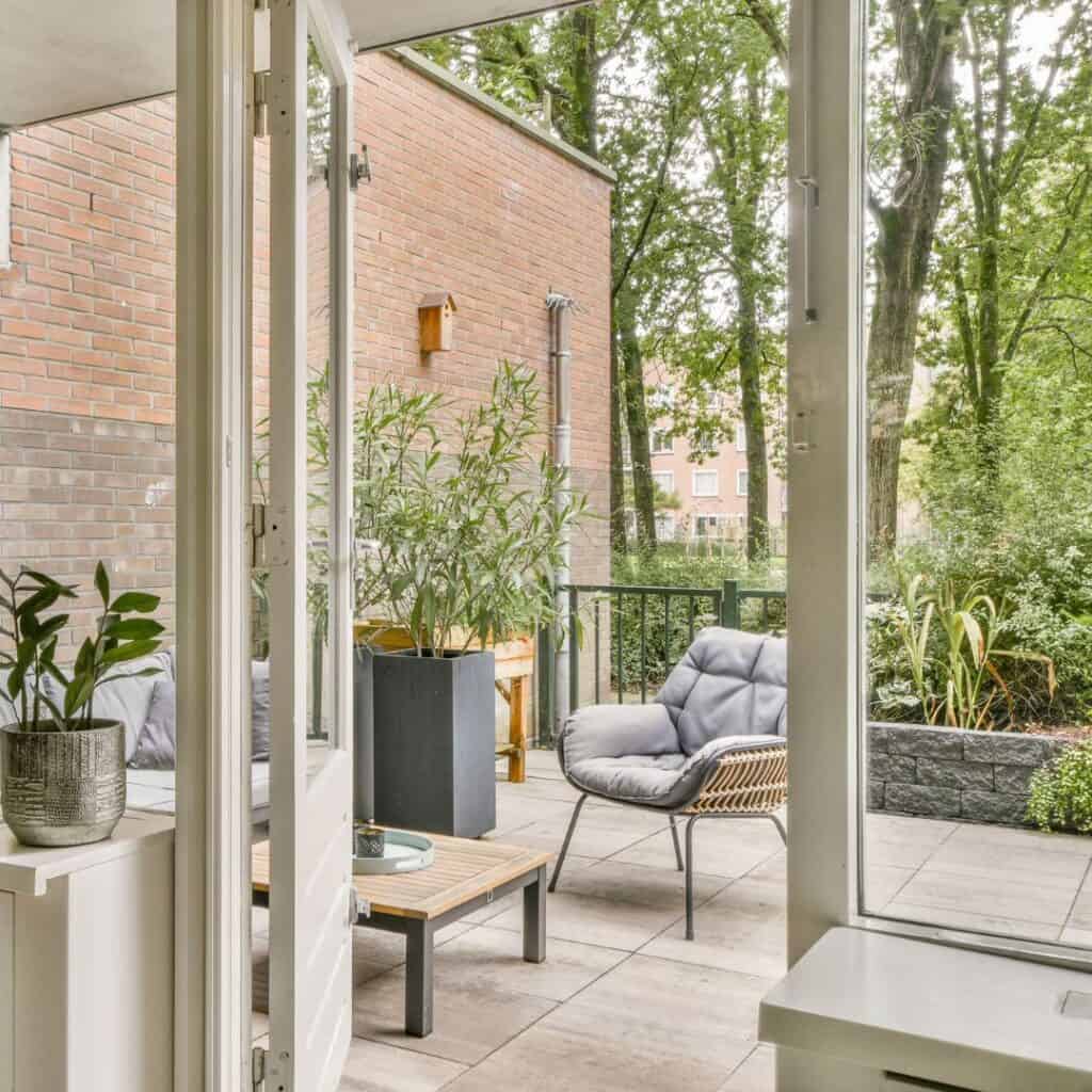 Balcony outdoor space featuring comfortable seating and lush plants, perfect for relaxation in Ronde.